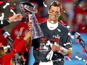 Tampa Bay Buccaneers quarterback Tom Brady (12) celebrates with the Vince Lombardi Trophy after beating the Kansas City Chiefs in Super Bowl LV at Raymond James Stadium.