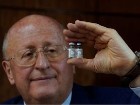Alexander Gintsburg, director of the Gamaleya National Research Center for Epidemiology and Microbiology, shows bottles with Sputnik-V vaccine against the coronavirus disease (COVID-19) during an interview with Reuters in Moscow, Russia September 24, 2020. Picture taken September 24, 2020.