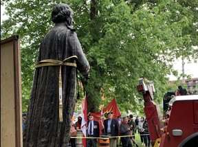Crews remove a statue of Canada's first prime minister, Sir John A. Macdonald, from City Park in downtown Kingston, Ont., where it has stood since 1895, on Friday, June 18, 2021.