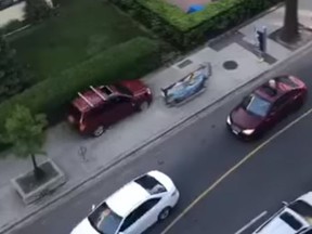 A stolen SUV careens down the sidewalk along Jameson Ave. just north of King St. W. on Sunday, May 30, 2021 in this screengrab taken from video posted to Facebook.