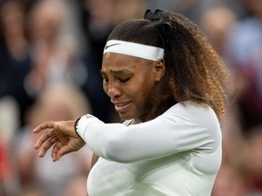 Tennis - Wimbledon - All England Lawn Tennis and Croquet Club, London, Britain - June 29, 2021 Serena Williams of the U.S. reacts after sustaining an injury before retiring from her first round match against Belarus' Aliaksandra Sasnovich