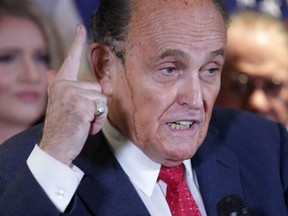 Sweat runs down the face of former New York City Mayor Rudy Giuliani, personal attorney to U.S. President Donald Trump, as he speaks about the 2020 U.S. presidential election results during a news conference at Republican National Committee headquarters in Washington, U.S., November 19, 2020.