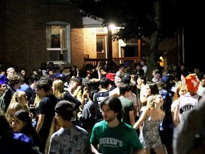 Partygoers gather on Aberdeen Street near Queen's University in Kingston on Sunday, July 4, 2021.