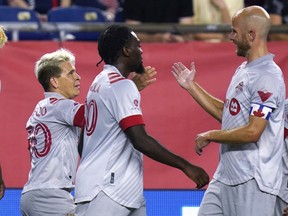Toronto FC midfielder Yeferson Soteldo, left, is congratulated by midfielder Michael Bradley, right, after his goal in the first half of an MLS soccer match against the New England Revolution on Wednesday.