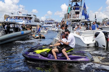 Alex Killorn #17 of the Tampa Bay Lightning holds the Stanley Cup while driving Nikita Kucherov #86 during the boat parade to celebrate the Tampa Bay Lightning winning the Stanley Cup July 12, 2021 in Tampa, Florida. (Photo by Mike Carlson/Getty Images) *** BESTPIX ***