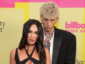 Machine Gun Kelly and Megan Fox poses backstage for the 2021 Billboard Music Awards, broadcast on May 23, 2021 at Microsoft Theater in Los Angeles, California.