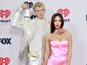 Machine Gun Kelly, winner of the Alternative Rock Album of the Year award for 'Tickets To My Downfall,' and Megan Fox attend the 2021 iHeartRadio Music Awards at The Dolby Theatre in Los Angeles, California, which was broadcast live on FOX on May 27, 2021.