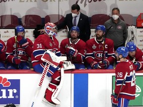 Carey Price sits on the boards with his dejected Canadiens teammates late in their Game 3 loss to Tampa Bay.