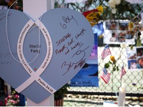 A note left by former NBA player Dwyane Wade of the Miami Heat is seen at the memorial site for victims of the collapsed 12-story Champlain Towers South condo building on July 08, 2021 in Surfside, Florida.