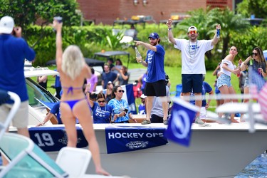 Barclay Goodrow (right) and Brayden Point (left) of the Tampa Bay Lightning celebrate with fans during the 2021 Stanley Cup Victory parade on the Hillsborough River on July 12, 2021 in Tampa, Florida. (Photo by Julio Aguilar/Getty Images)
