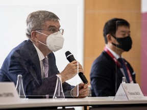 IOC President Thomas Bach (L) speaks to Tokyo 2020 President Seiko Hashimoto during their meeting at the Tokyo 2020 Headquarters on July 13, 2021 in Tokyo, Japan.