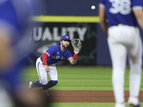 Bo Bichette of the Toronto Blue Jays makes a diving catch to get out Nick Solak of the Texas Rangers during the fifth inning at Sahlen Field on July 16, 2021 in Buffalo, New York.