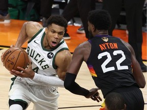 Giannis Antetokounmpo  of the Milwaukee Bucks drives to the basket against against Deandre Ayton of the Phoenix Suns during the second half in Game Five of the NBA Finals at Footprint Center on July 17, 2021 in Phoenix, Arizona.