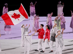 Flag bearers Miranda Ayim and Nathan Hirayama of Team Canada lead their team out during the Opening Ceremony of the Tokyo 2020 Olympic Games at Olympic Stadium on July 23, 2021 in Tokyo, Japan.