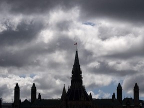 Clouds pass by the parliament buildings on Aug. 19, 2020 in Ottawa.