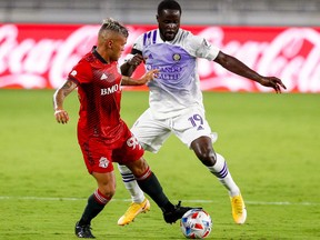 Toronto FC defender Auro (96) controls the ball against Orlando City forward Benji Michel (19) in the second half at Orlando City Stadium.  Nathan