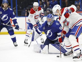 Lightning goaltender Andrei Vasilevskiy  makes a save as Canadiens' Corey Perry looks for a rebound during the third period in Game 2 of the Stanley Cup final at Amalie Arena on Wednesday night.