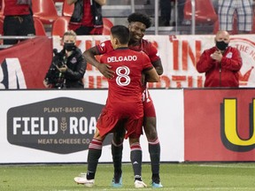 Toronto FC midfielder Ralph Priso (97) celebrates scoring a goal with midfielder Marco Delgado (8) during the second half against the New York Red Bulls at BMO Field on Wednesday.