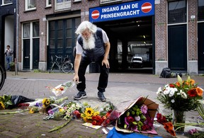 Bystanders lay flowers, candles and messages of support for Peter R. de Vries in the Lange Leidsedwarsstraat, central Amsterdam on July 7, 2021, after the crime reporter was shot.