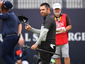 South Africa's Louis Oosthuizen reacts on the 18th green after his first-round 64 on day one of The 149th British Open Golf Championship at Royal St George's.