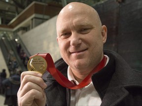 Team Canada assistant coach and Ottawa 67's head coach Andre Tourigny shows off the gold medal after Canada beat Team Russia 4-3 at the World Junior Championships in the Czech Republic, Jan. 6, 2020.