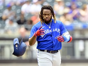 Vladimir Guerrero Jr. of the Toronto Blue Jays tosses his helmet after flying out against the New York Mets during the third inning at Citi Field on July 25, 2021 in the Queens borough of New York City.
