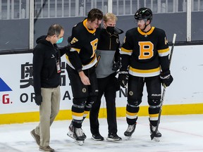 Boston Bruins defenceman Brandon Carlo (25) skates off the ice after suffering an apparent injury against the Washington Capitals at TD Garden.