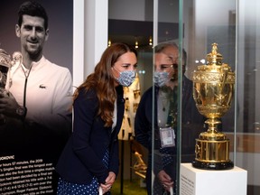 Catherine, Duchess of Cambridge is shown around the Wimbledon Museum by the Head of Heritage at the All England Lawn Tennis Club Adam Chadwick during her official visit on day five of Wimbledon at The All England Lawn Tennis and Croquet Club, Wimbledon July 2, 2021.
