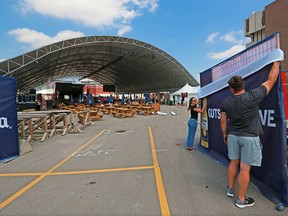 Final banners are installed at the entrance to Nashville North as the Calgary Stampede counted down the last few days before the start of the 2021 edition on Tuesday, July 6, 2021. The Stampede announced that guests entering Nashville North will need to provide proof of vaccination or agree to a rapid COVID-19 test.