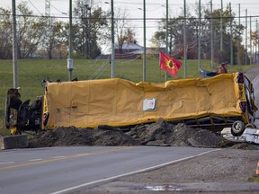 Protesters dug up the road on Argyle Street at the south end of Caledonia, Ont., adding an overturned school bus and car to the barricade in response to a judge granting a permanent injunction to McKenzie Meadows developers and Haldimand County after indigenous land defenders began an occupation of the residential construction site in July 2020.
