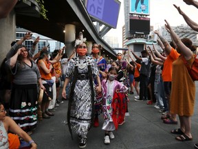 People participate in a traditional dance in honour of the victims and survivors of Canada's residential school system, after hundreds of remains of children were discovered at former Indigenous residential schools, on Canada Day at Yonge-Dundas Square in Toronto, July 1, 2021.