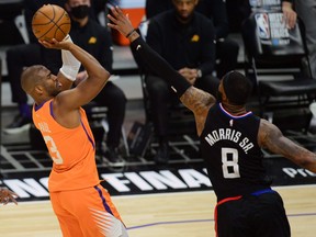 Phoenix Suns guard Chris Paul shoots against Los Angeles Clippers forward Marcus Morris Sr. during the second half in game six of the Western Conference Finals for the 2021 NBA Playoffs at Staples Center in Los Angeles, Calif., June 30, 2021.