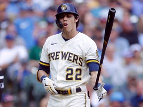 Christian Yelich of the Milwaukee Brewers throws his bat to the ground after striking out against the Kansas City Royals at American Family Field on July 21, 2021 in Milwaukee.