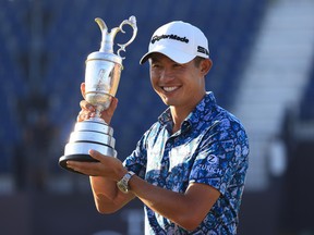 American Collin Morikawa poses with the Claret Jug after winning the 149th Open Championship at Royal St George’s on Sunday in Sandwich, England.