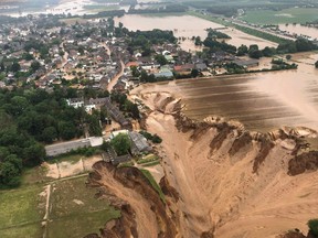 This handout photo obtained via the Twitter account of the district government of Cologne (Bezirksregierung Koln) from the Rhein-Erft-Kreis on July 16, 2021 shows an aerial view over the flooded town of Erftstadt following heavy rains.