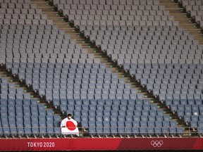 General view as a man in a protective face mask and the flag of Japan is seen in the stand during the Women's Group E soccer match between Chile and Japan at Miyagi Stadium in Miyagi, Japan, July 27, 2021.