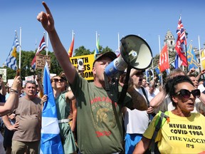 Protesters shout anti government slogans at the Houses of Parliament from Parliament Square as part of a freedom protest on July 19, 2021 in London.