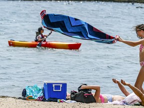 People enjoy the weather at  Sunnyside Beach in Toronto on June 5, 2021.