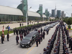 The hearse carrying the casket of Toronto Police Const. Jeffrey Northrup arrives for his funeral in Toronto, on Monday, July 12, 2021.