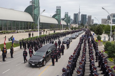 The hearse carrying the casket of Toronto Police Const. Jeffrey Northrup arrives for his funeral in Toronto, on Monday, July 12, 2021.