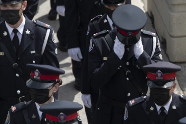 A police officer reacts as he arrives for the funeral of Toronto Police Const. Jeffrey Northrup in Toronto on Monday, July 12, 2021. (THE CANADIAN PRESS/Chris Young)