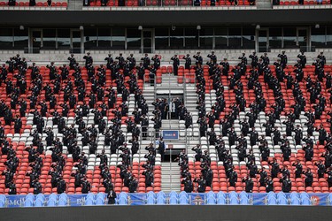 Police officers stand at attention during a funeral service for Toronto Police Const. Jeffrey Northrup at BMO stadium in Toronto, on Monday, July 12, 2021.