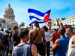 Cubans are seen outside Havana's Capitol during a demonstration against the government of Cuban President Miguel Diaz-Canel in Havana, on July 11, 2021.