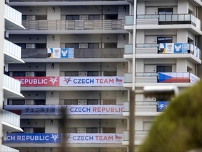 Banners of Czech Republic (bottom) and the Olympic Refugee team (top) are seen on a building at the Olympic and Paralympic Village on July 14, 2021, ahead of the 2020 Tokyo Olympics which begin on July 23.