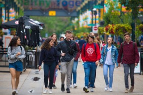 People walk in downtown Calgary after city council voted July 5, 2021 to rescind the mandatory masking bylaw in the city. Mandatory masking for transit and inside city owned and operated facilities will remain for the time being.
