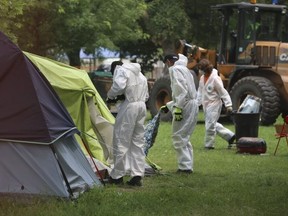 Crews are pictured demolishing an encampment at Alexandra Park on July 21, 2021.