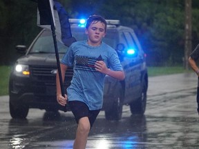 Zechariah Cartledge, 12, runs for Toronto Police Const. Jeffrey Northrup who was killed while on duty on July 2.