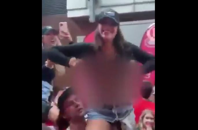 Female Canadiens fan flashes crowd during Game 4 victory celebration