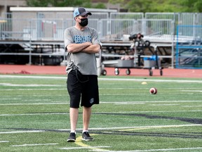 New head coach Ryan Dinwiddie surveys the players drills during Day 1 of the Argonauts training camp yesterday at the University of Guelph.
