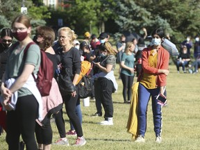 People line up for a pop-up vaccination clinic at Dentonia Park, in East York near Danforth and Victoria Park Aves. on June 20, 2021.